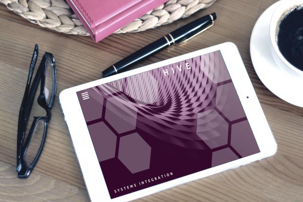 Flat lay of a modern workspace featuring a tablet displaying a screen, glasses, coffee, and a pen on a wooden desk.